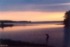 There's a sandbar connecting the "island" to the mainland, and there's two boys playing on the sandbar.